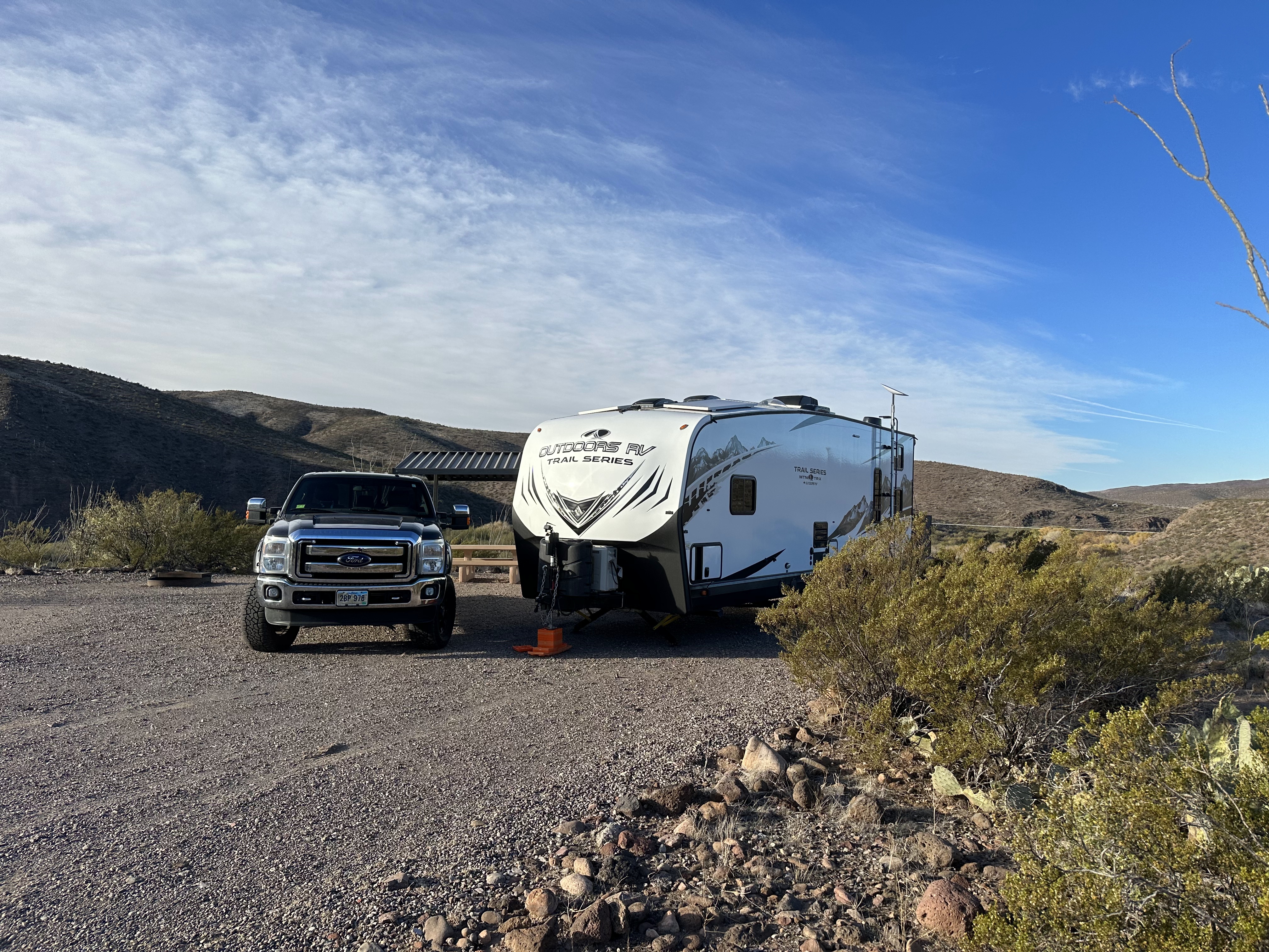 Ford F-350 towing Outdoors RV Mountain Trail 29TRX toy hauler travel trailer